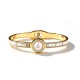 BRACCIALE RIGIDO A MOLLA CON PERLA TONDA CENTRALE E STRASS - DH25100B481