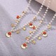 COLLANA DI PERLE CON CHARMS NATALIZI - JN2592C24 COLLANA DI PERLE CON CHARMS NATALIZI - JN2592C24
